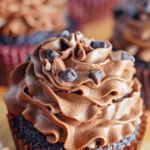 Pinterest image of a close-up shot of chocolate cupcake piped with chocolate buttercream frosting with chocolate chips on top.