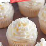Pinterest image of wedding cupcakes piped with buttercream frosting on a baking tray.