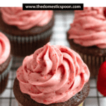 Pinterest image of chocolate cupcakes topped with strawberry cream cheese frosting on a rack.