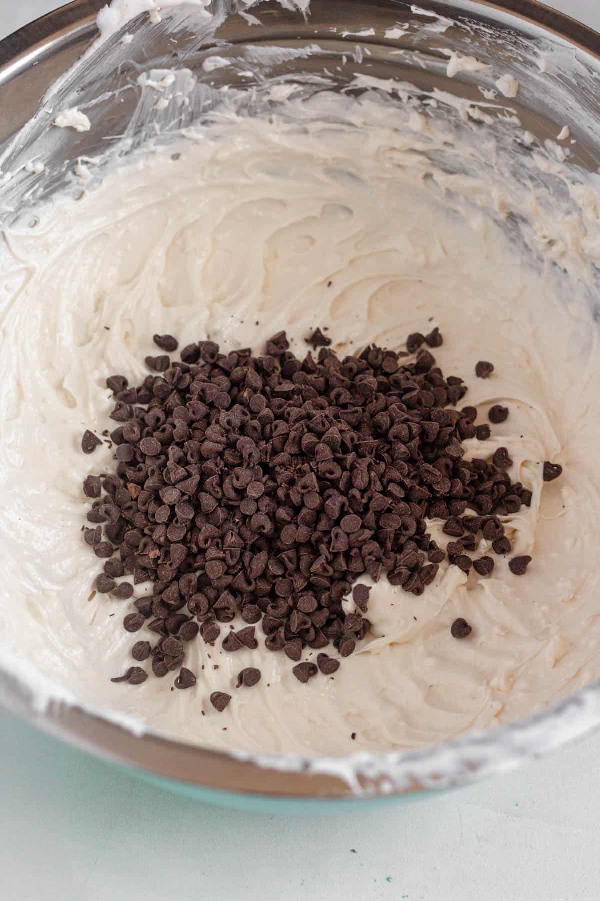 mixing bowl filled with booty dip, topped with mini chocolate chips