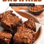 Pinterest image of brownies sprinkled with salt, cut into squares, stacked on top of each other, served on a plate.