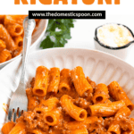 Pinterest image of the spicy rigatoni on a bowl with a fork on the side.