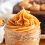 Pinterest image of a close-up shot of piped Peanut Butter Ganache in a glass jar.