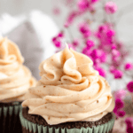 Pinterest image of Cinnamon Cream Cheese Frosting piped on top of a chocolate cupcake.