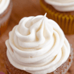 Pinterest image of a top view of a cupcake with maple cream cheese frosting piped on top.
