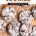 Pinterest image of a top view of crack cookies lying on parchment paper with powdered sugar coating them to show the chocolate cracks.