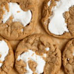Pinterest image of a close-up of the fluffernutter cookies resting on brown parchment paper.