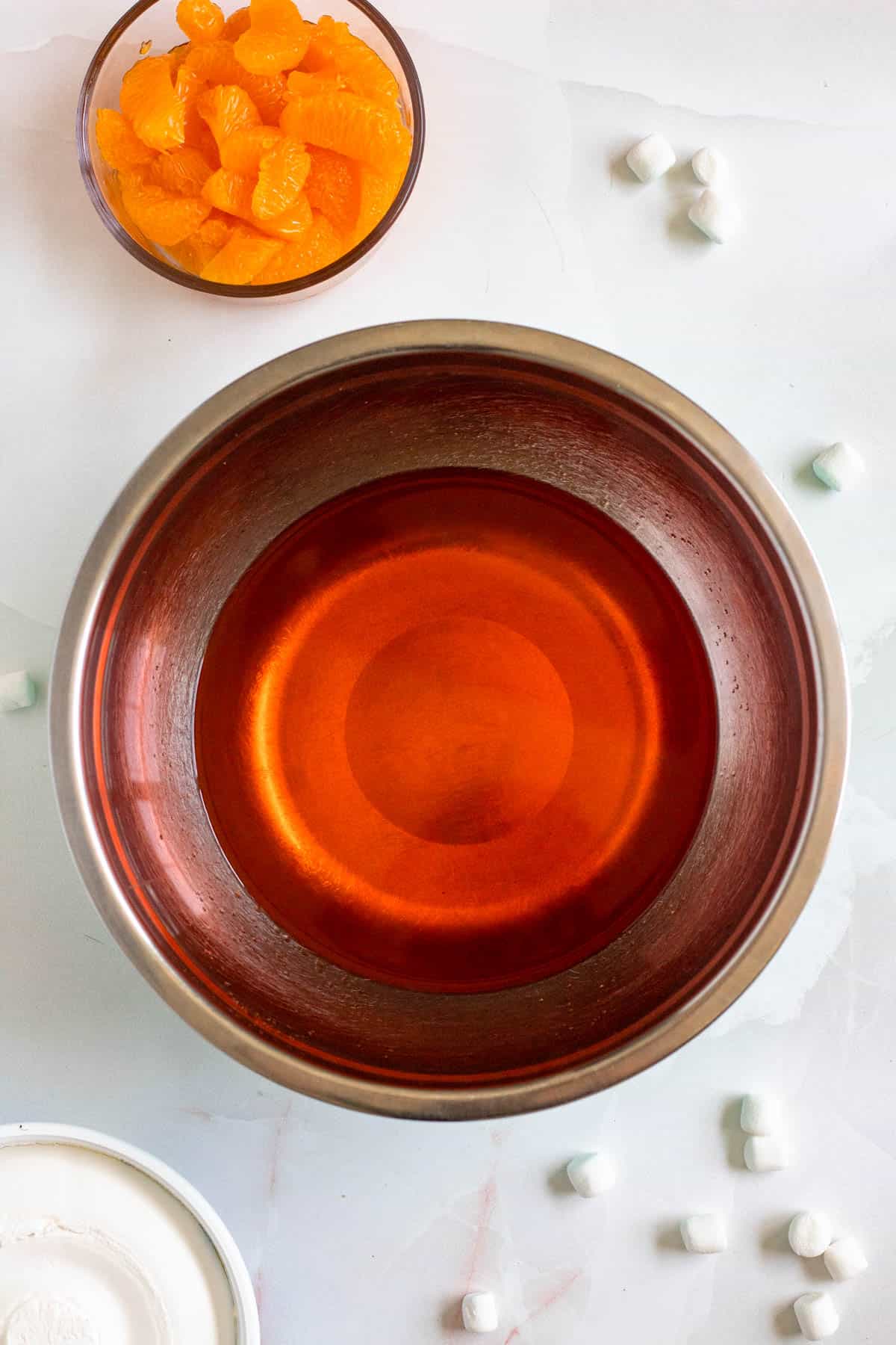 Orange jello stirred into boiling hot water.