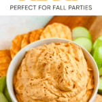 Pinterest image of pumpkin dip with cool whip in a mixing bowl on a cutting board with graham crackers, apple slices and waffle cone dippers around it.