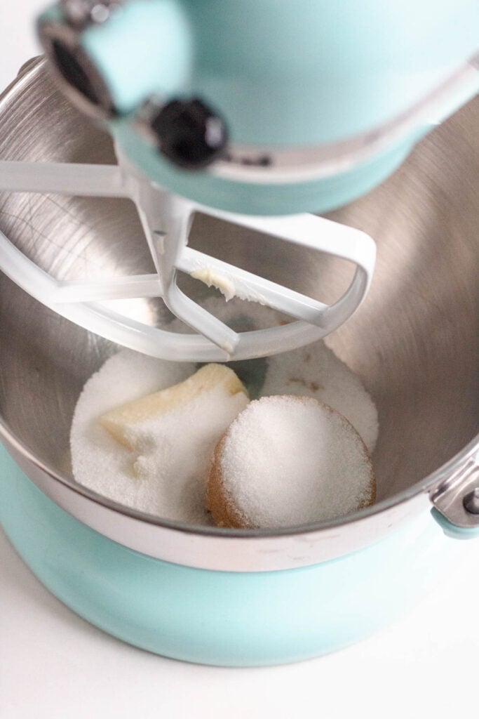 Butter, brown sugar, and sugar are in the mixer bowl, ready to be mixed.