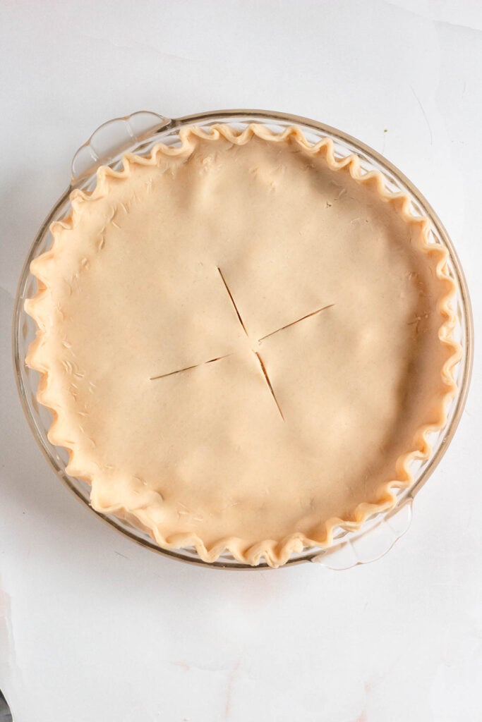 The pie was topped with a second crust, edges sealed, and slits cut to vent steam.