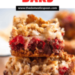Pinterest image of a close-up of stacked cherry bars filled with coconut, chocolate chips, walnuts, and a graham cracker crust.