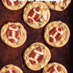Pinterest image of a top-view shot of freshly baked Football Cookies in a baking tray.
