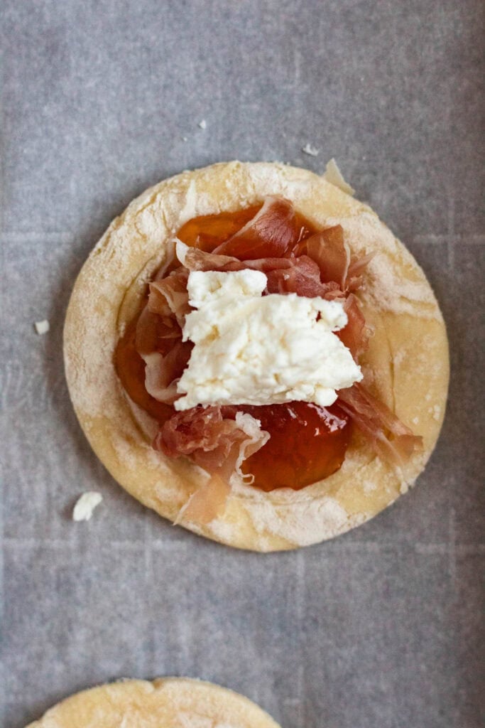 Puff pastry circles filled with apricot jam, prosciutto, and goat cheese.