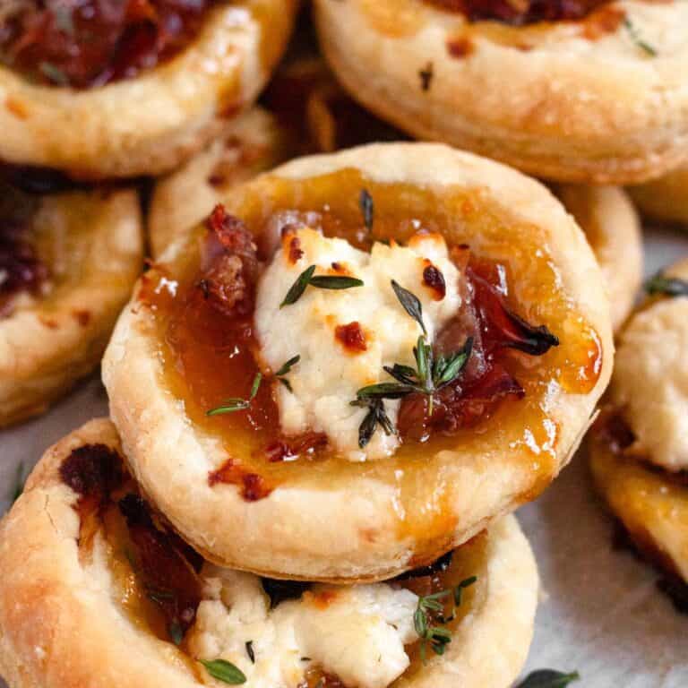 Delicious Goat Cheese Appetizer with apricot jam topped with fresh herbs.