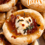 Pinterest image of a close-up shot of a pile of goat cheese puff pastry bites on parchment paper.