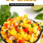 Pinterest image of Mango Pico de Gallo in a white cup with tortilla chips on the side.