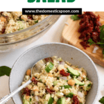 Pinterest image of a bowl of flavorful and light Mediterranean Quinoa Salad with a spoon.