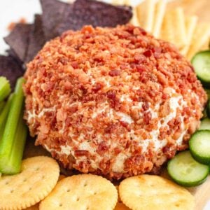 A 3 Ingredient Cheese Ball served with crackers, cucumber slices, and celery sticks.
