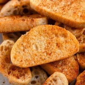 Close-up of golden crostini slices with crisp edges and lightly seasoned.