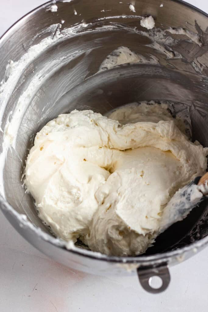 A bowl of smooth, creamy mixture of cream cheese and whipped cream.