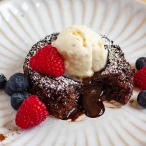 Molten Chocolate Lava Cake topped with vanilla ice cream and fresh berries.