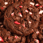 Pinterest image of a close-up shot of a stack of Chocolate Peppermint Cookies on a white plate, with peppermint and chocolate chip on the side.