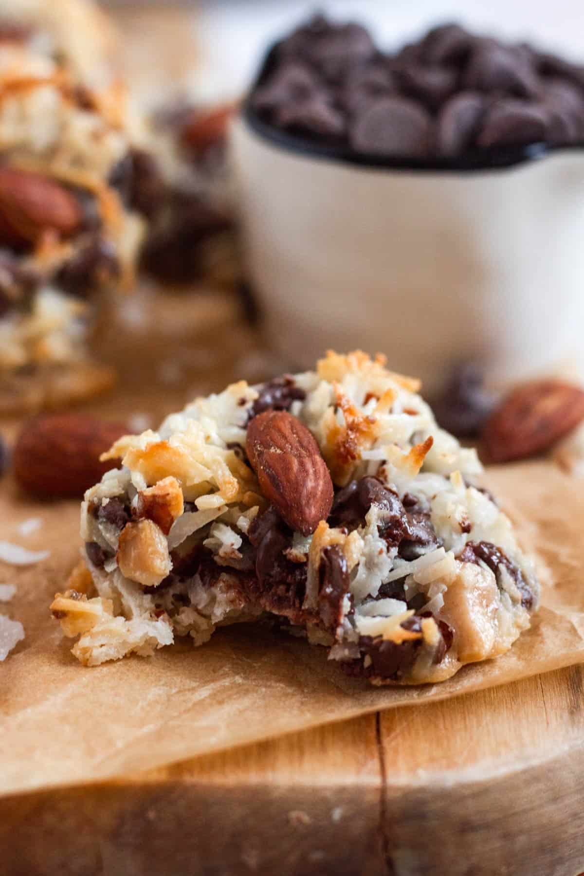 Close-up of a chewy Almond Joy Cookie showing the melted chocolate chips and toasted coconut texture.