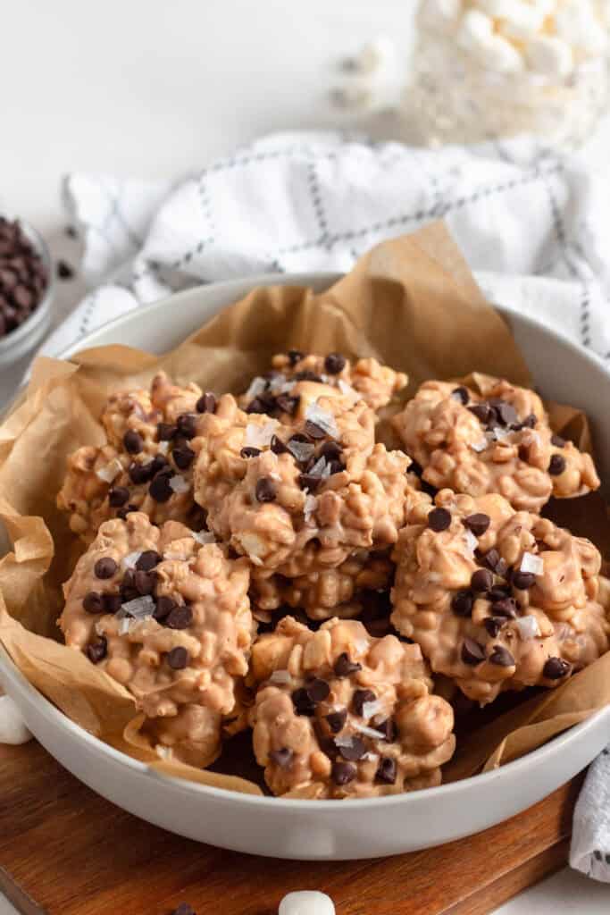 A bowl of Avalanche cookies topped with chocolate chips and flaky sea salt.