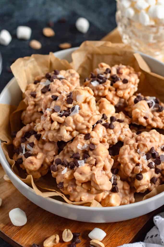A bowl of Avalanche cookies topped with chocolate chips and flaky sea salt.