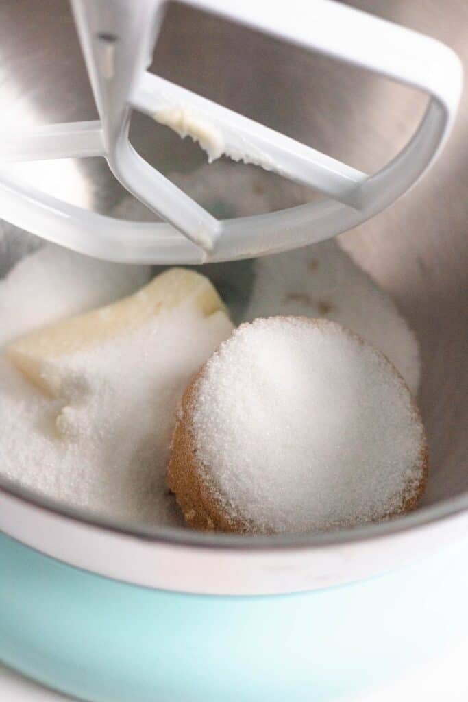 Butter, brown sugar, and granulated sugar in a stand mixer bowl ready to be creamed.