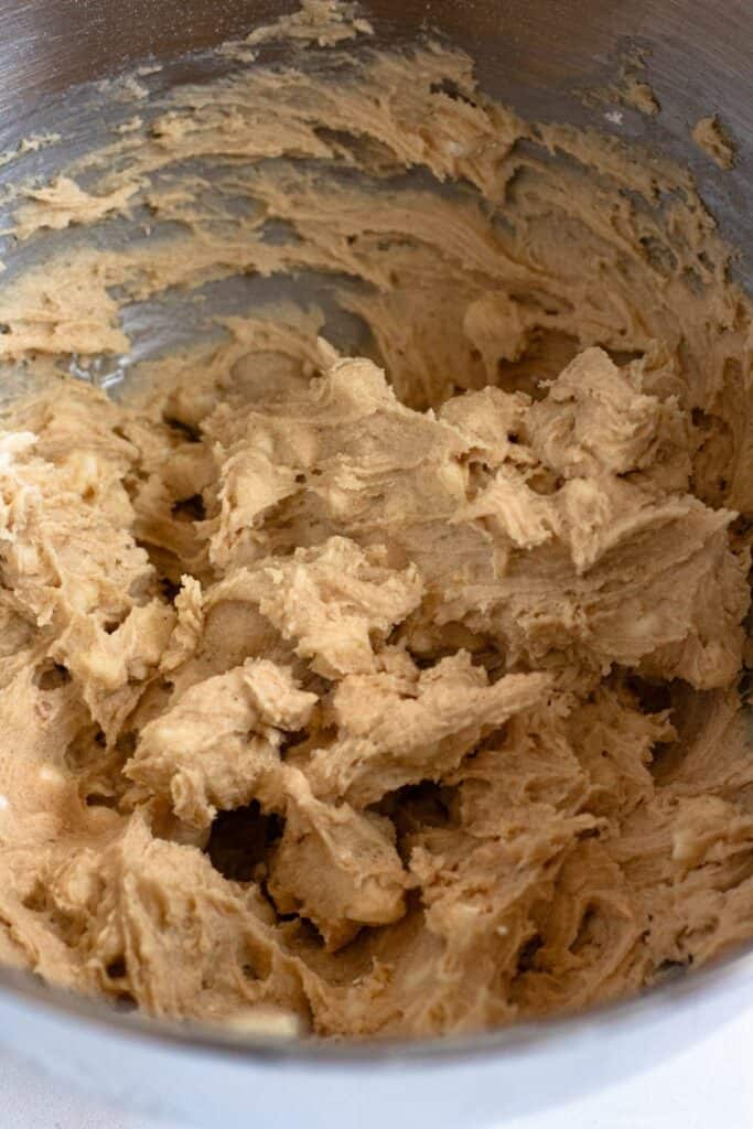 Close-up of the texture of mixed white chocolate chip cookie dough in a bowl.