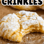 Pinterest image of a close-up shot of Lemon Cake Mix Cookies dusted with powdered sugar, one with a bite taken out.